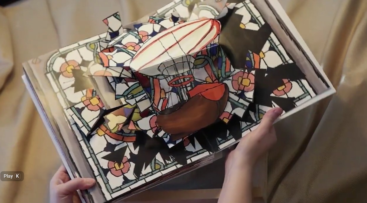 Open pop-up book showing the final dirigible spread.